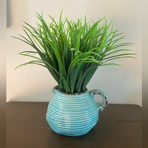 Fake plant in blue pitcher pot
